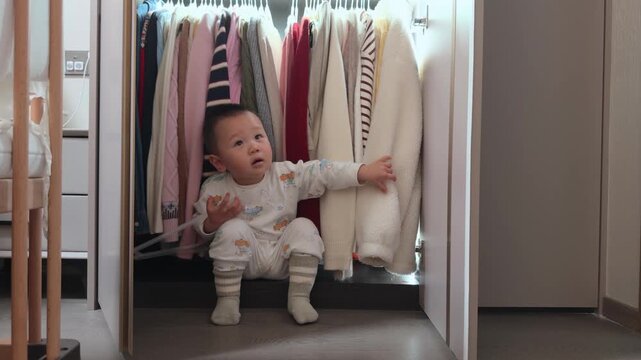 Curious Little Asian Boy Exploring and Messing Around in Mother's Wardrobe.