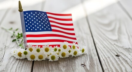 Obraz premium Small american flag with white daisy flowers on a rustic wooden background