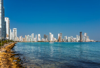 Obraz premium Modern skyline of Cartagena, Colombia, with skyscrapers along the Caribbean Sea under a clear blue sky