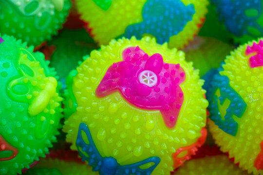 Neon spiky sensory rubber balls closeup, fidget toys in green and red