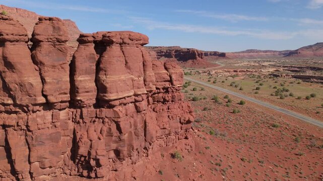 Fly past red rock butte to reveal empty, twisty Scenic Utah highway 95 