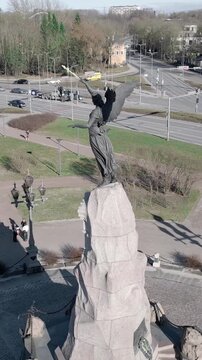 Vertical aerial video of Russalka Memorial statue overlooking beach and Baltic Sea in Tallinn Estonia