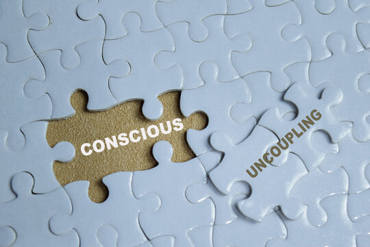 Piece of jigsaw puzzle with word conscious uncoupling. Represents a peaceful divorce and breakup or mindful separation