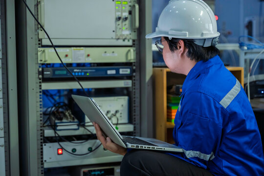 Engineer working at control room In large industrial plants,Manager control system,Technician man monitoring program from a lot of monitor,Concept Industry