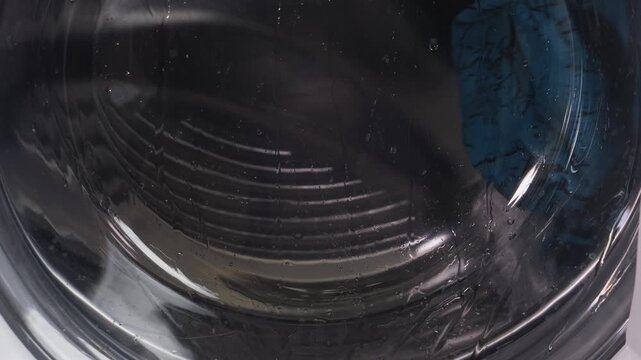 The washing machine is washing clothes, the drum is spinning