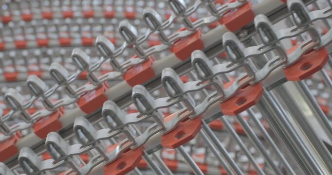 A multi-tiered spiral conveyor in operation, stainless steel mesh belts moving in different directions. A working transport system with an axisless spiral. Close-up handheld indoors shot, real time sp