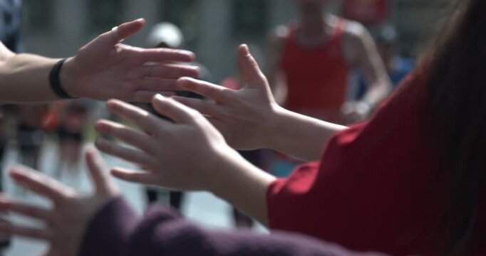 Runners at S25 Berlin city running event, high fives in Berlin, Germany