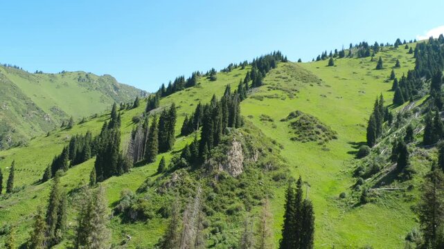 View from the funicular to the green mountain peaks. Cable car, climb up the mountains on summer season.