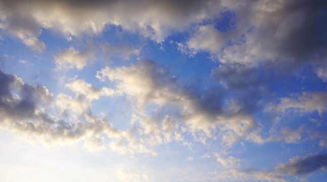 a clear afternoon sky with white and black clouds