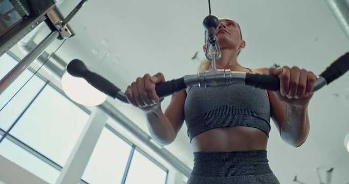 Active Woman Training on Strength Machine in Modern Fitness Center