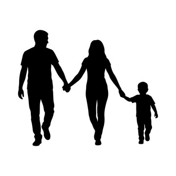 Silhouette of a family of three holding hands and walking together