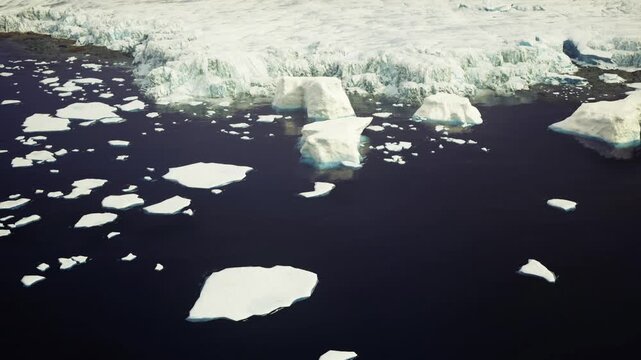 Soft polar dawn over Antarctic drifting ice and quiet sea, gentle warm tones mingling with cold blues, expansive perspective of glacier edge and scattered floes