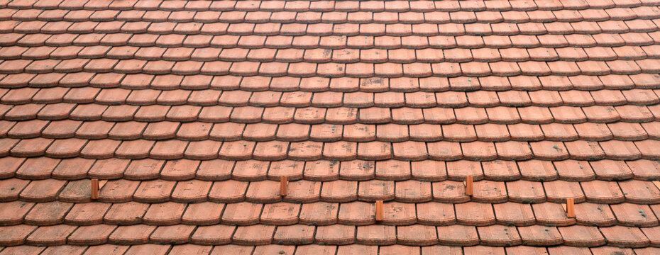New broken Segmental beaver tail terracotta roof tiles pattern on traditional European house