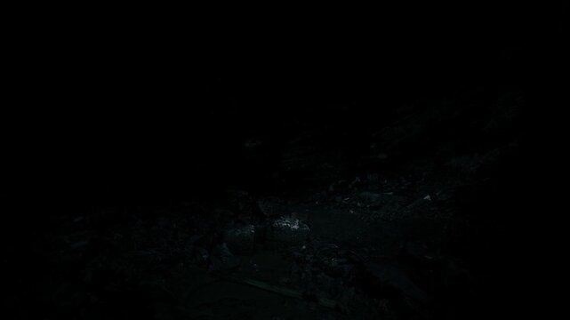 Shadowy rough terrain with highlights. Somber black landscape exhibiting rough formations and subtle shimmering details across textured grounds