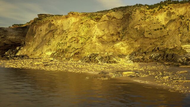 moody overcast light on chalk cliffs, muted colors and dramatic cloud movement, restless sea and wet rock foreground, evocative backdrop for editorial mood