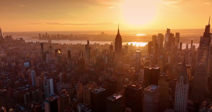 New York panorama covered with soft light of sunset. Golden hour drone footage over metropolis.
