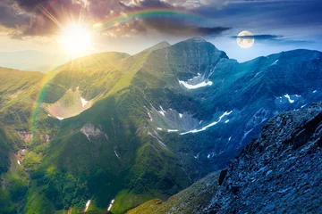 day meet night. mountain scenery on summer solstice. sun and moon over gorgeous mountainous landscape. background with rocky cliffs and grassy hillsides under a epic sky. ridge of southern mountains © Pellinni