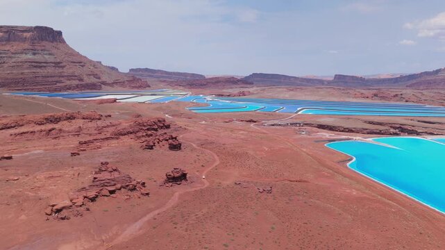 Fly over colorful blue potash evaporation ponds in Moab Utah with Jeep