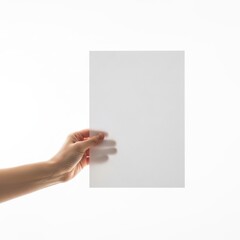 Obraz premium A hand holding a blank white rectangular card or sheet