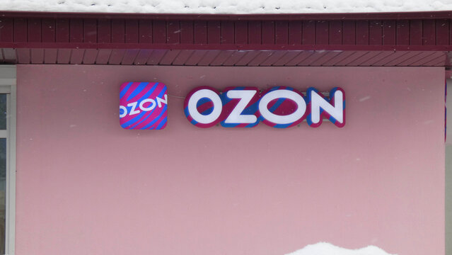The OZON company sign on a building with a pink wall in winter, when there is snow on the ground.In Belarus, in the city of Minsk, on December 12, 2025.