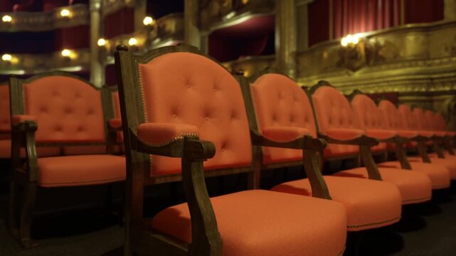 Closeup tufted chair armrests capture antique texture and carved woodwork, upholstery details highlighted by soft amber lighting, craftsmanship and pattern