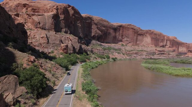 Aerial of Scenic road on Colorado river in Moab Utah with high sandstone cliff