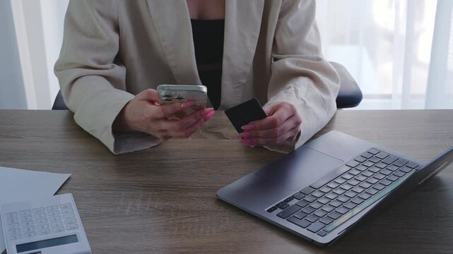 Entering a password to use a credit card.
A woman uses a bank card to pay for digital purchases.
Transferring money to the card using a mobile phone.