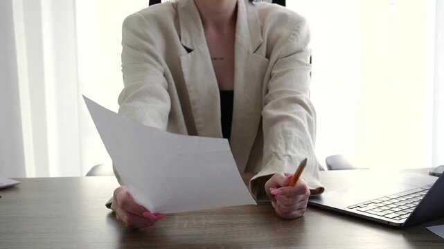 A businesswoman hands over documents for signature.
Recruitment and interview.
Cooperation agreement with a business company.
A businesswoman hands over a blank sheet of paper for someone to sign.