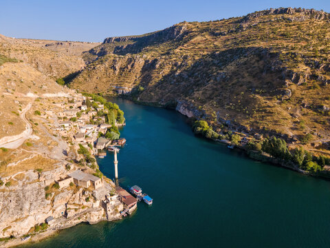 Savasan Village in Halfeti, Sanliurfa, T&uuml;rkiye, is partially submerged by the Euphrates due to the Birecik Dam, creating a striking scene of abandoned houses and rising waters.