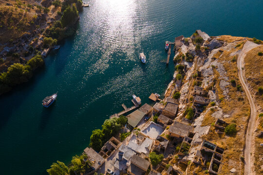 Savasan Village in Halfeti, Sanliurfa, T&uuml;rkiye, is partially submerged by the Euphrates due to the Birecik Dam, creating a striking scene of abandoned houses and rising waters.