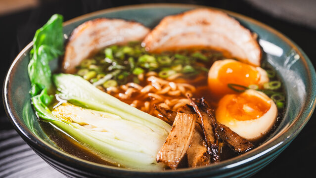 Creative homemade ramen using instant noodles combined with tender chashu pork belly, soft boiled egg, fresh bok choy, bamboo shoots and scallions in a rich pork broth with soy umami flavor. Fusion of