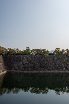 Osaka Castle Tower Rising Above Stone Walls and Moat