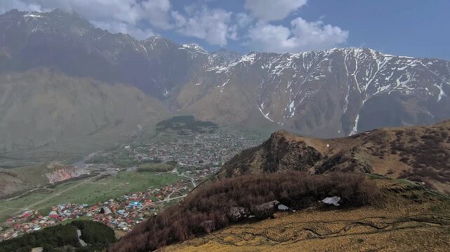A view of the village of Stepantsminda against the backdrop of the majestic Caucasus mountains. Georgia.
