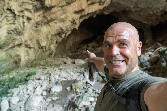 Hiker taking a selfie in a cave