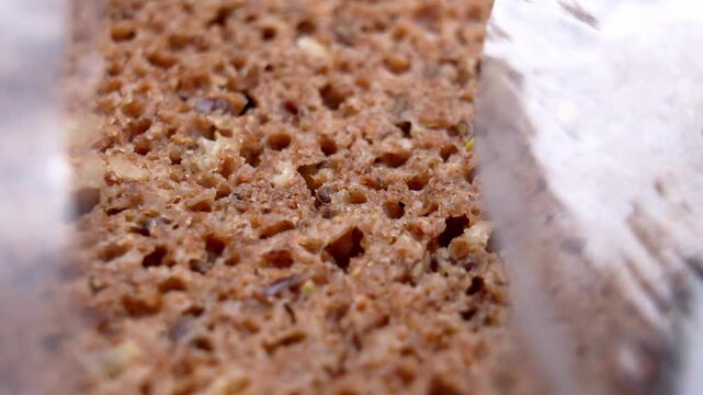 Packaged whole grain sliced bread in open plastic bag. Supermarket product. Rotation