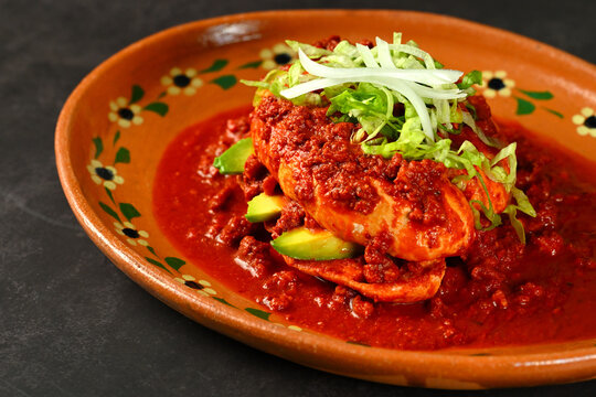 Mexican pambazo sandwich with chorizo and avocado in guajillo sauce, Mexican food