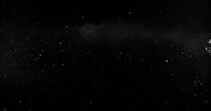 Super slow motion bullet impact shattering glass filmed at 1000fps. Side view of gunshot breaking window with flying shards and dust isolated on black background. Perfect VFX overlay element.