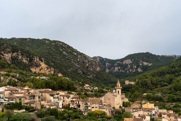 Obraz premium Mediterranean village with church in mountain valley landscape