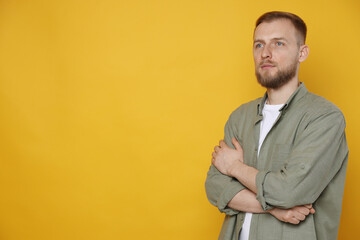 Fototapeta premium Portrait of handsome man on orange background, space for text