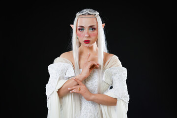 Obraz premium Portrait of beautiful elf girl on black background