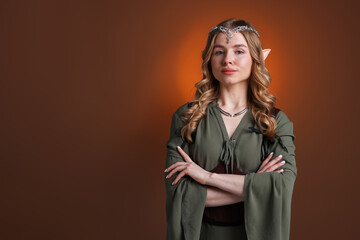 Obraz premium Portrait of beautiful elf girl on brown gradient background, space for text