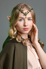Obraz premium Portrait of beautiful elf girl on grey background