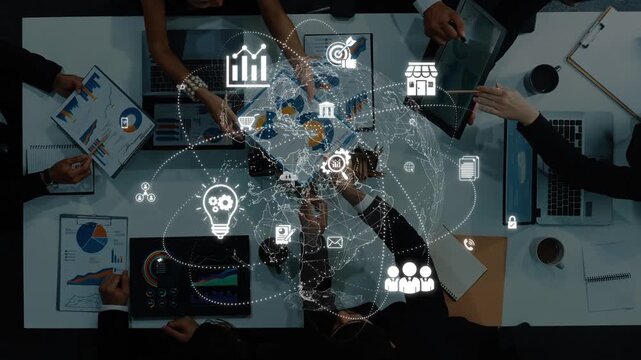 A top view of a diverse team engaged in a business strategy meeting, utilizing digital tools and graphics to enhance communication and data analysis. Raster
