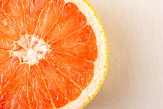 Half of a grapefruit on a light surface 