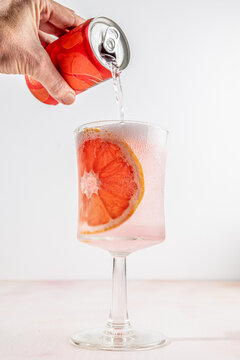 Pink grapefruit soda with a slice of grapefruit for garnish 