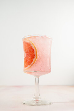 Pink grapefruit soda with a slice of grapefruit for garnish 
