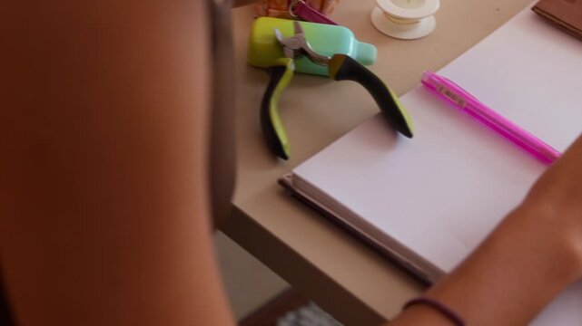 Jewelry designer crafting handmade earrings with pliers
