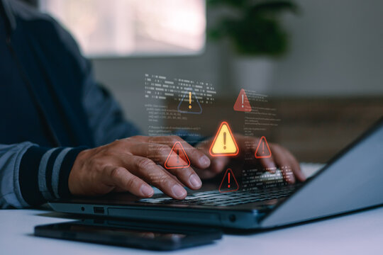 Concept of cyber security breach, computer virus, data system failure and software bug error. Professional programmer or hacker hand typing on laptop with warning alert icons and coding overlay.