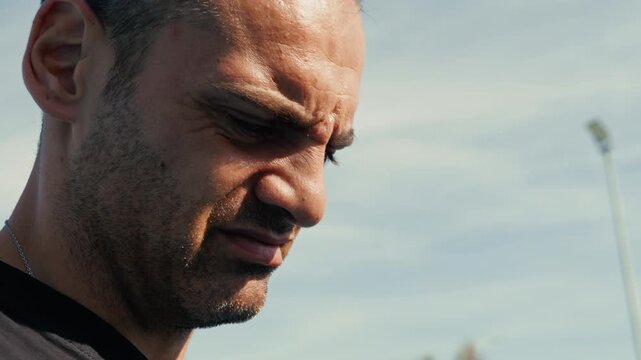 man squinting his eyes and making grimaces