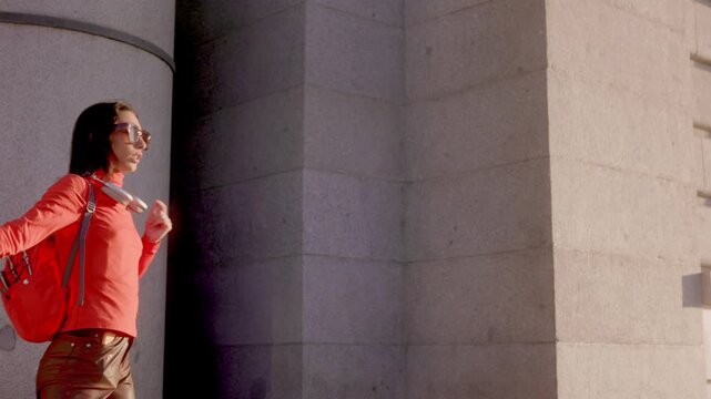 Happy female traveler dancing in Almudena Cathedral, Madrid city
